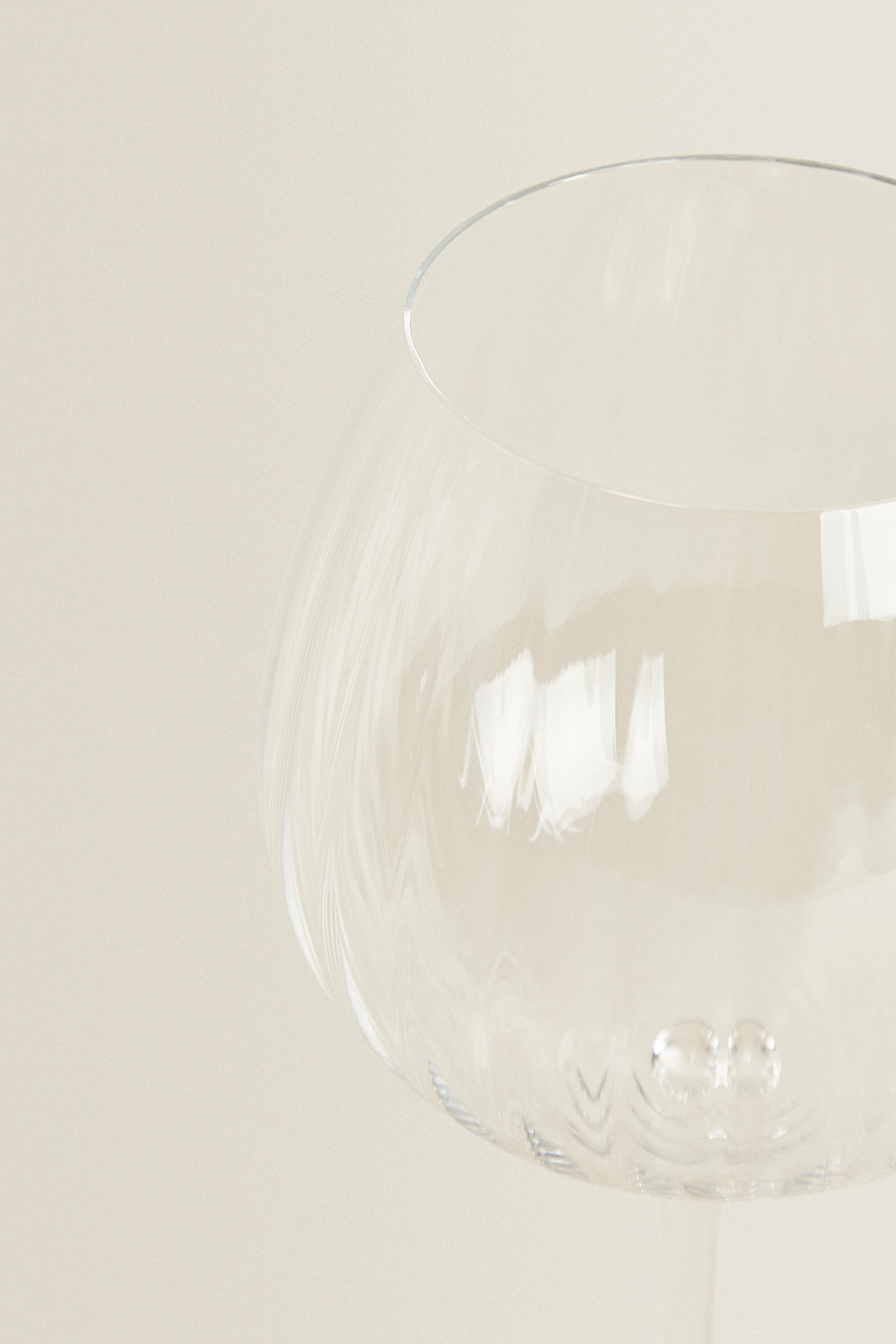 CRYSTALLINE GLASS WITH A RAISED DESIGN