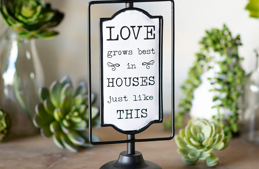 Enamel Love Grows Sign on Stand