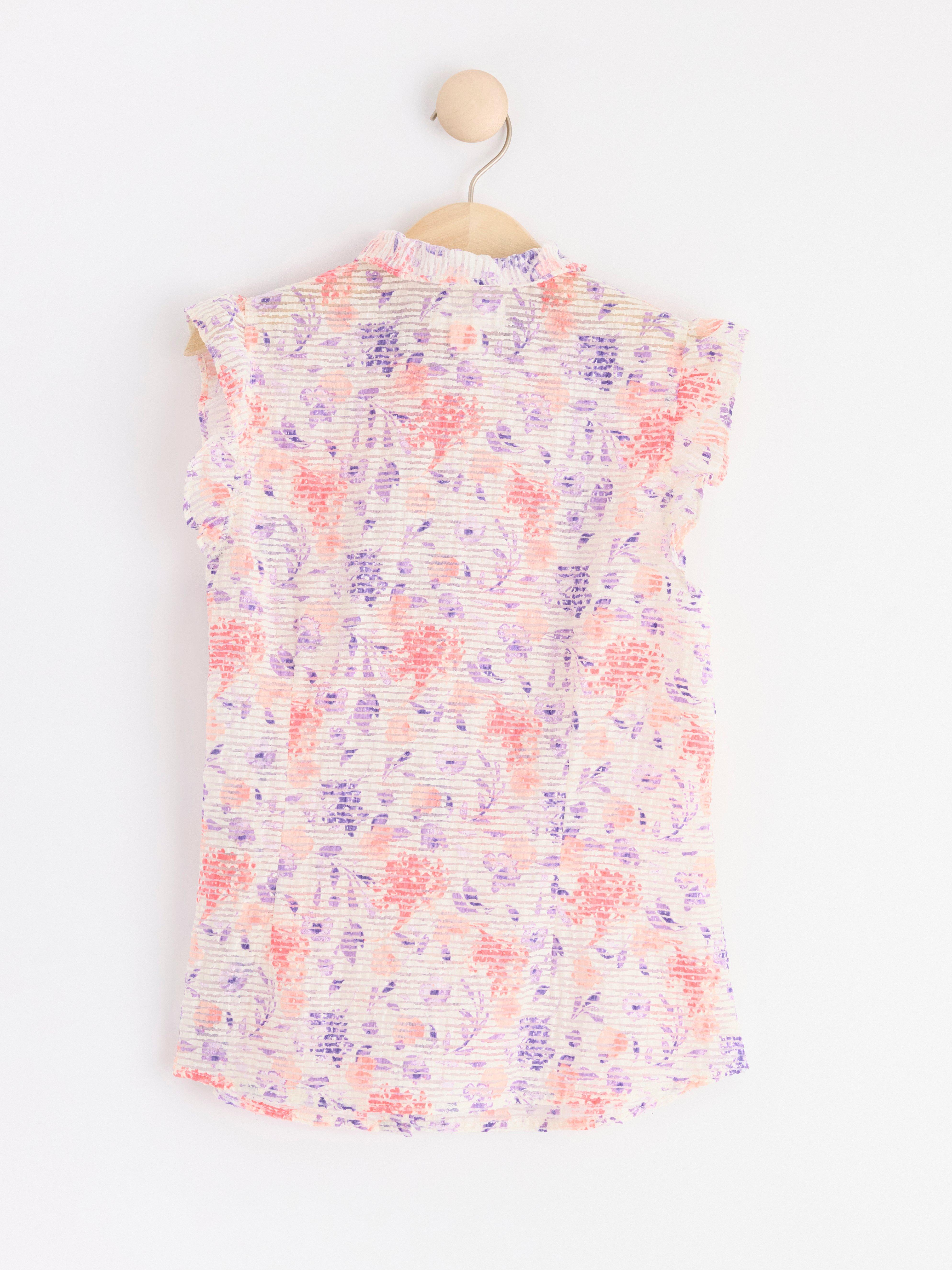Sleeveless blouse with frills Coral