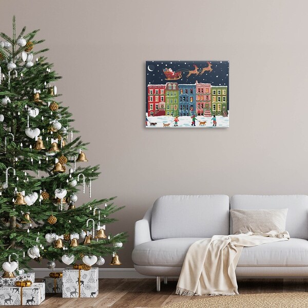 Stupell Snowy Christmas Town Santa Overhead Canvas Wall Art by Nancy McKenzie