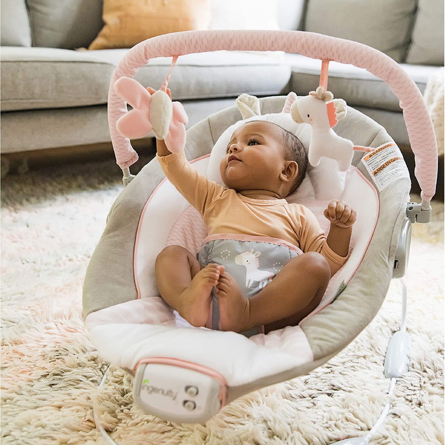 Ingenuity Soothing Baby Bouncer with Vibrating Infant Seat. Music. Removable -Toy Bar & 2 Plush Toys - Flora the Unicorn (Pink). 0-6 Months