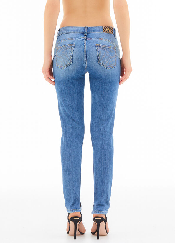 Jeans skinny con strappi e strass