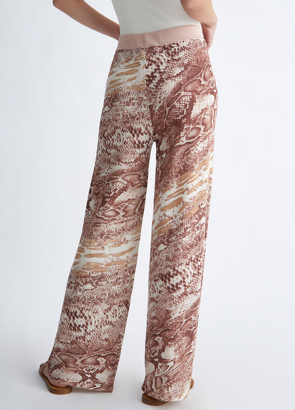 Pantaloni con stampa pitonata